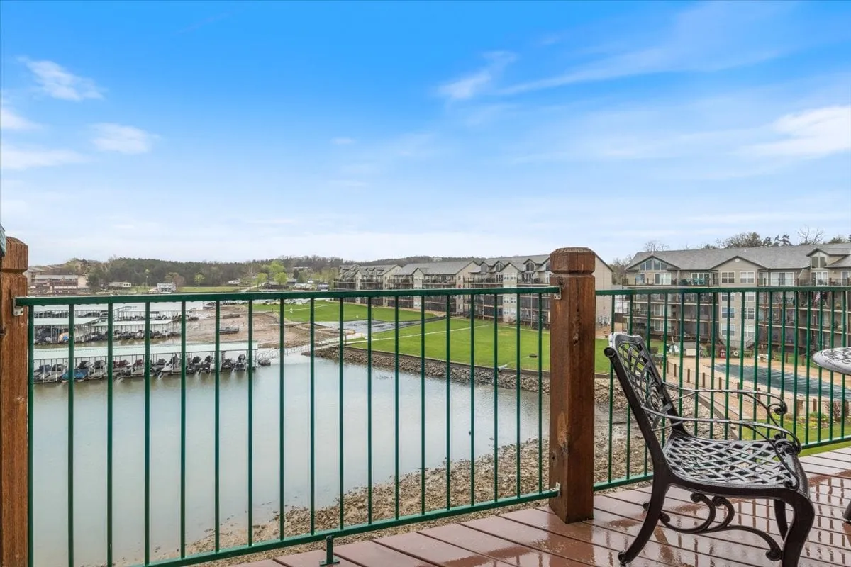 A peaceful dock area with a wide view of the water, green lawn, and a decorative chair—ideal for fishing, boating, or relaxing. The open expanse and dock access emphasize the lake lifestyle.